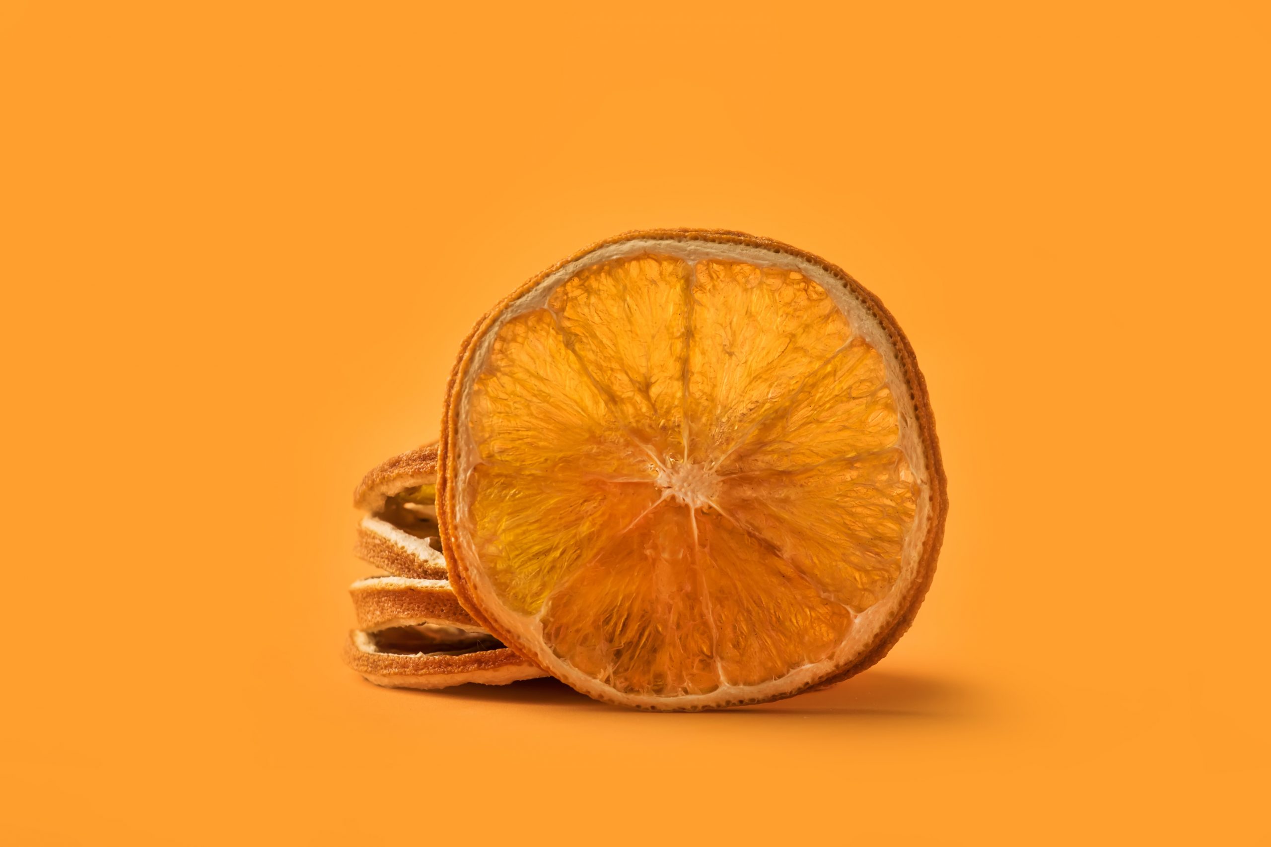Christmas spice dried orange on bright orange background
